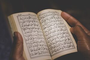 muslim man reading quran in medina saudi arabia