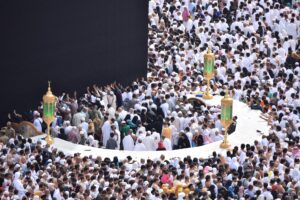 muslims performing umrah and touching and kissing hajr e aswad black Stone